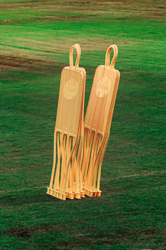 Two orange soccer training mannequins on a lush green field, ideal soccer training equipment.